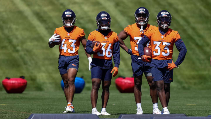 May 23, 2024; Englewood, CO, USA; Denver Broncos running back Blake Watson (43) and running back Tyler Badie (36) and running back Audric Estime (37) and running back Javonte Williams (33) look on as full back Michael Burton (20) runs a drill during organized team activities at Centura Health Training Center. Mandatory Credit: Isaiah J. Downing-USA TODAY Sports