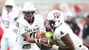 Oct 18, 2025; Fayetteville, Arkansas, USA; Texas A&M Aggies quarterback Marcel Reed (10) and running back Rueben Owens II (4) warm up prior to the game against the Arkansas Razorbacks at Donald W. Reynolds Razorback Stadium. Mandatory Credit: Nelson Chenault-Imagn Images