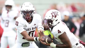 Oct 18, 2025; Fayetteville, Arkansas, USA; Texas A&M Aggies quarterback Marcel Reed (10) and running back Rueben Owens II (4) warm up prior to the game against the Arkansas Razorbacks at Donald W. Reynolds Razorback Stadium. Mandatory Credit: Nelson Chenault-Imagn Images