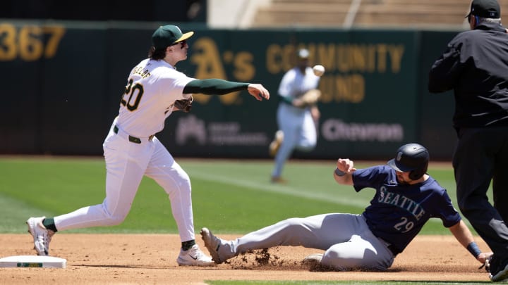 Oakland Athletics second baseman Zack Gelof (left) turns a double play during a game against the Seattle Mariners on June 6 at Oakland Coliseum.