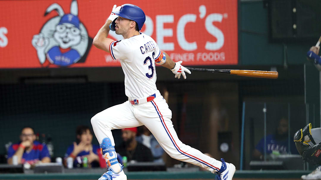 Apr 23, 2026; Arlington, Texas, USA; Texas Rangers center fielder Evan Carter (32) hits a two-run inside the park home run during the third inning against the Pittsburgh Pirates at Globe Life Field. Mandatory Credit: Kevin Jairaj-Imagn Images