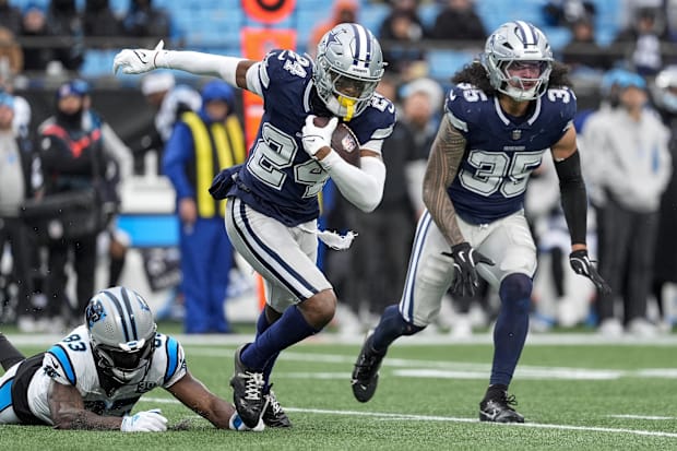 Dallas Cowboys safety Israel Mukuamu runs after intercepting a pass from Carolina Panthers quarterback Bryce Young.