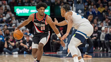 Feb 8, 2025; Minneapolis, Minnesota, USA; Portland Trail Blazers guard Scoot Henderson (00) is defended by Minnesota Timberwolves guard Jaylen Clark (22) in the second quarter at Target Center. Mandatory Credit: Matt Blewett-Imagn Images