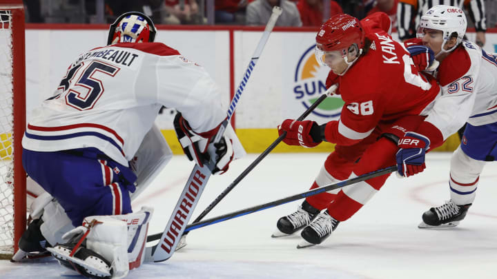 Apr 15, 2024; Detroit, Michigan, USA;  Detroit Red Wings right wing Patrick Kane (88) skates with the puck on Montreal Canadiens goaltender (35) while defended by Montreal Canadiens defenseman Justin Barron (52) in overtime at Little Caesars Arena. Mandatory Credit: Rick Osentoski-USA TODAY Sports