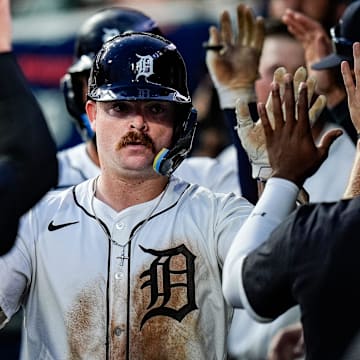 Detroit Tigers catcher Jake Rogers (34) high-fives teammates after scoring a run against Colorado Rockies during the fifth inning at Comerica Park in Detroit on Wednesday, September 11, 2024.