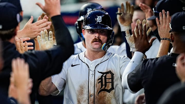 Detroit Tigers catcher Jake Rogers (34) high-fives teammates after scoring a run against Colorado Rockies during the fifth inning at Comerica Park in Detroit on Wednesday, September 11, 2024.