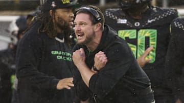 Oct 25, 2025; Eugene, Oregon, USA; Oregon Ducks head coach Dan Lanning instructs players during the first half against the Wisconsin Badgers at Autzen Stadium. Mandatory Credit: Troy Wayrynen-Imagn Images