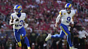 Nov 9, 2025; Santa Clara, California, USA; Los Angeles Rams running back Kyren Williams (23) runs for a touchdown as Los Angeles Rams quarterback Matthew Stafford (9) watches during the first quarter against the San Francisco 49ers at Levi's Stadium. Mandatory Credit: Kyle Terada-Imagn Images