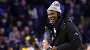 Jan 27, 2025; Ann Arbor, Michigan, USA;  Michigan Wolverines quarterback Bryce Underwood participates in a t-shirt toss during a time out in the second half against the Penn State Nittany Lions at Crisler Center. Mandatory Credit: Rick Osentoski-Imagn Images