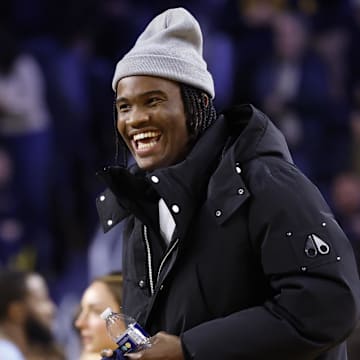 Jan 27, 2025; Ann Arbor, Michigan, USA;  Michigan Wolverines quarterback Bryce Underwood participates in a t-shirt toss during a time out in the second half against the Penn State Nittany Lions at Crisler Center. Mandatory Credit: Rick Osentoski-Imagn Images