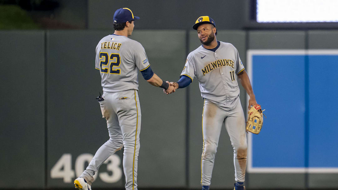Jun 20, 2025; Minneapolis, Minnesota, USA; Milwaukee Brewers designated hitter Christian Yelich (22) and center fielder Jackson Chourio (11) celebrate after defeating the Minnesota Twins at Target Field. Mandatory Credit: Jesse Johnson-Imagn Images