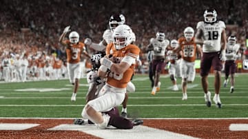 Nov 28, 2025; Austin, Texas, USA; Texas Longhorns quarterback Arch Manning keeps the ball and runs for a touchdown during the second half against the Texas A&M Aggies at Darrell K Royal-Texas Memorial Stadium. Mandatory Credit: Scott Wachter-Imagn Images