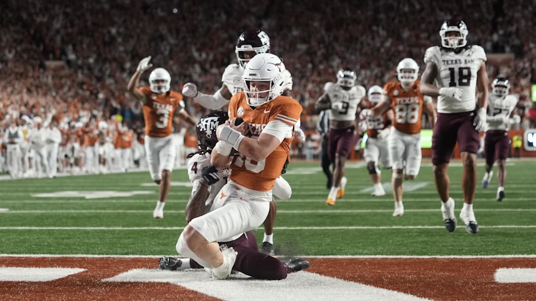 Texas Longhorns quarterback Arch Manning keeps the ball and runs for a touchdown during the second half against the Texas A&M Aggies
