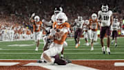Texas Longhorns quarterback Arch Manning keeps the ball and runs for a touchdown during the second half against the Texas A&M Aggies
