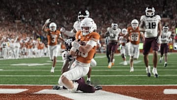 Texas Longhorns quarterback Arch Manning keeps the ball and runs for a touchdown during the second half against the Texas A&M Aggies