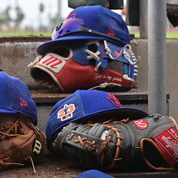 Mar 22, 2023; Scottsdale, Arizona, USA; A detail view of Texas Rangers hats and gloves during a Spring Training game against the San Francisco Giants at Scottsdale Stadium. 