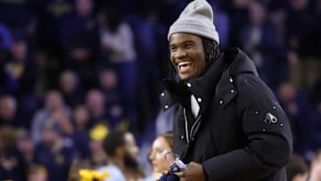 Jan 27, 2025; Ann Arbor, Michigan, USA;  Michigan Wolverines quarterback Bryce Underwood participates in a t-shirt toss during a time out in the second half against the Penn State Nittany Lions at Crisler Center. Mandatory Credit: Rick Osentoski-Imagn Images