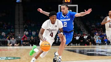 Nov 27, 2024; Las Vegas, Nevada, USA; Texas A&M Aggies guard Wade Taylor IV (4) dribbles against Creighton Bluejays guard Pop Isaacs (2) during the first half at MGM Grand Garden Arena. Mandatory Credit: Stephen R. Sylvanie-Imagn Images