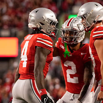 Sep 7, 2024; Columbus, Ohio, USA; Ohio State Buckeyes wide receiver Jeremiah Smith (4) celebrates scoring a touchdown with wide receiver Emeka Egbuka (2) and quarterback Will Howard (18) during the first half of the NCAA football game at Ohio Stadium.