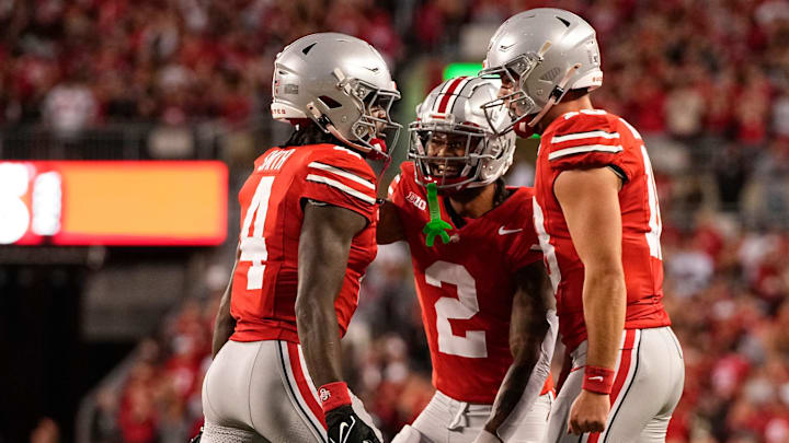 Sep 7, 2024; Columbus, Ohio, USA; Ohio State Buckeyes wide receiver Jeremiah Smith (4) celebrates scoring a touchdown with wide receiver Emeka Egbuka (2) and quarterback Will Howard (18) during the first half of the NCAA football game at Ohio Stadium.