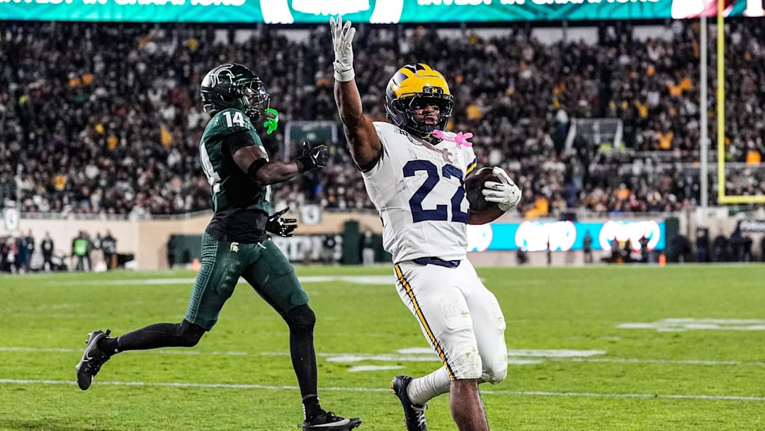 Michigan running back Justice Haynes (22) runs for a touchdown against Michigan State defensive back Malcolm Bell (14) during the second half at Spartan Stadium in East Lansing on Saturday, October 25, 2025.