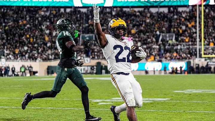 Michigan running back Justice Haynes (22) runs for a touchdown against Michigan State defensive back Malcolm Bell (14) during the second half at Spartan Stadium in East Lansing on Saturday, October 25, 2025.