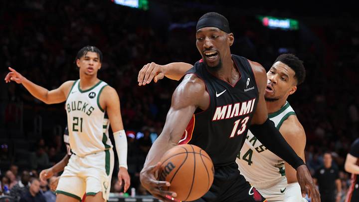 Mar 12, 2026; Miami, Florida, USA; Miami Heat center Bam Adebayo (13) protects the basketball against Milwaukee Bucks forward Giannis Antetokounmpo (34) during the third quarter at Kaseya Center. Mandatory Credit: Sam Navarro-Imagn Images