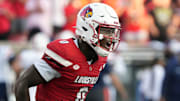 Louisville’s Chris Bell celebrates scoring a touchdown against Virginia at L&N Stadium Saturday