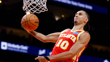 Hawks forward Zaccharie Risacher (10) dunks the ball during a game against the Lakers. 