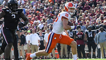 Clemson quarterback Trevor Lawrence (16) runs for a first down year South Carolina defensive tackle Javon Kinlaw(3) during the first quarter at Williams-Brice Stadium in Columbia, South Carolina Saturday, November 30, 2019.