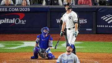 Oct 30, 2024; New York, New York, USA; New York Yankees designated hitter Giancarlo Stanton (27) hits a solo home run off of Los Angeles Dodgers pitcher Ryan Brasier (57) during the third inning in game four of the 2024 MLB World Series at Yankee Stadium. Mandatory Credit: Robert Deutsch-Imagn Images