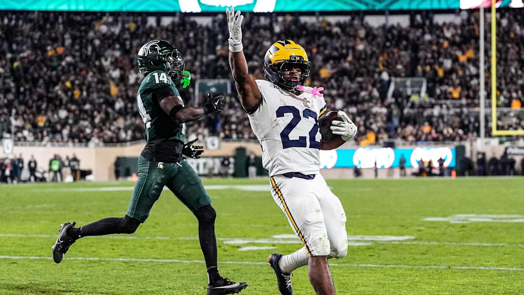 Michigan running back Justice Haynes (22) runs for a touchdown against Michigan State defensive back Malcolm Bell (14) during the second half at Spartan Stadium in East Lansing on Saturday, October 25, 2025.