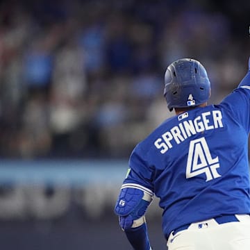 Jul 3, 2025; Toronto, Ontario, CAN; Toronto Blue Jays designated hitter George Springer (4) celebrates as he runs the bases on his two run home run against the New York Yankees during the eighth inning at Rogers Centre. 