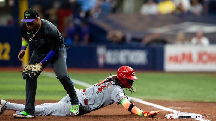 Jul 27, 2024; St. Petersburg, Florida, USA; Cincinnati Reds shortstop Elly De La Cruz (44) slides to first base past Tampa Bay Rays first base Isaac Paredes (17) during the sixth inning at Tropicana Field. Mandatory Credit: Matt Pendleton-USA TODAY Sports