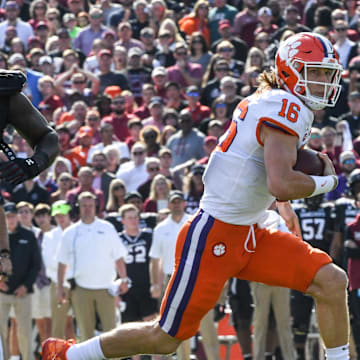 Clemson quarterback Trevor Lawrence (16) runs for a first down year South Carolina defensive tackle Javon Kinlaw(3) during the first quarter at Williams-Brice Stadium in Columbia, South Carolina Saturday, November 30, 2019.