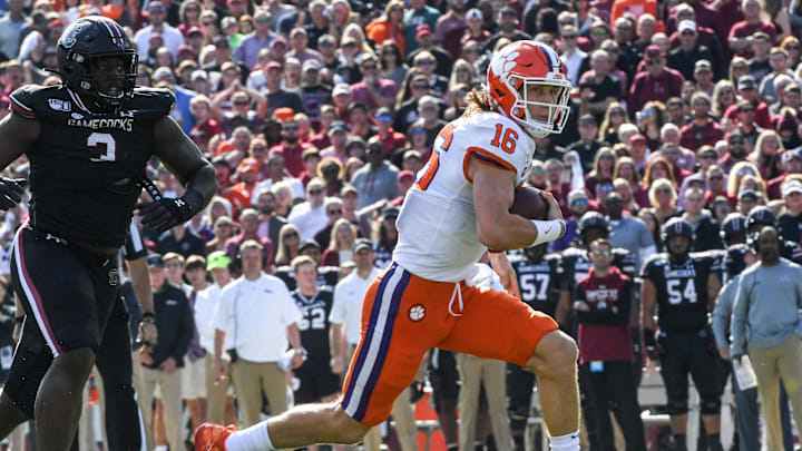 Clemson quarterback Trevor Lawrence (16) runs for a first down year South Carolina defensive tackle Javon Kinlaw(3) during the first quarter at Williams-Brice Stadium in Columbia, South Carolina Saturday, November 30, 2019.