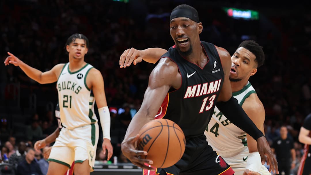 Mar 12, 2026; Miami, Florida, USA; Miami Heat center Bam Adebayo (13) protects the basketball against Milwaukee Bucks forward Giannis Antetokounmpo (34) during the third quarter at Kaseya Center. Mandatory Credit: Sam Navarro-Imagn Images