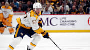 Apr 15, 2024; Pittsburgh, Pennsylvania, USA;  Nashville Predators defenseman Dante Fabbro (57) skates with puck against the Pittsburgh Penguins during the second period at PPG Paints Arena. Mandatory Credit: Charles LeClaire-Imagn Images