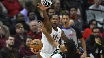 Dec 3, 2025; Cleveland, Ohio, USA; Cleveland Cavaliers center Evan Mobley (4) defends a shot by Portland Trail Blazers guard Shaedon Sharpe (17) in the fourth quarter at Rocket Arena. Mandatory Credit: David Richard-Imagn Images