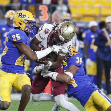 Nov 4, 2023; Pittsburgh, Pennsylvania, USA;  Pittsburgh Panthers defensive back Stephon Hall (25) commits a targeting penalty by hitting Florida State Seminoles wide receiver Vandrevius Jacobs (19) after a catch as Pitt defensive back Cruce Brookins (34) tackles during the fourth quarter against at Acrisure Stadium. The Seminoles won 24-7. Mandatory Credit: Charles LeClaire-USA TODAY Sports