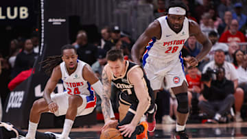 Nov 18, 2025; Atlanta, Georgia, USA; Atlanta Hawks guard Vit Krejci (27) dives for a loose ball with Detroit Pistons guard Daniss Jenkins (24) and forward Isaiah Stewart (28) in the second quarter at State Farm Arena. Mandatory Credit: Brett Davis-Imagn Images
