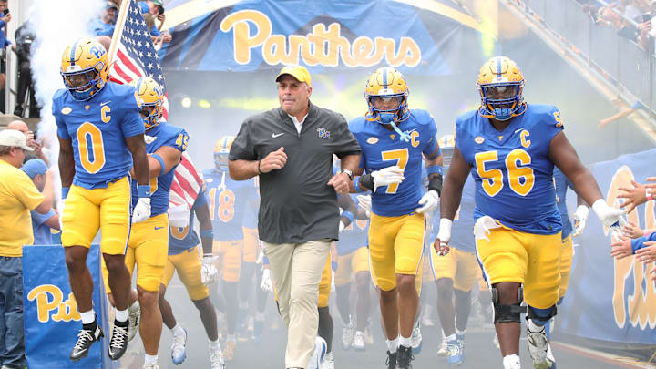 Sep 6, 2025; Pittsburgh, Pennsylvania, USA;  Pittsburgh Panthers running back Desmond Reid (0), head coach Pat Narduzzi, defensive back Javon McIntyre (7) and offensive lineman Lyndon Cooper (56) lead the Panthers onto the field to play the Central Michigan Chippewas  at Acrisure Stadium. Mandatory Credit: Charles LeClaire-Imagn Images
