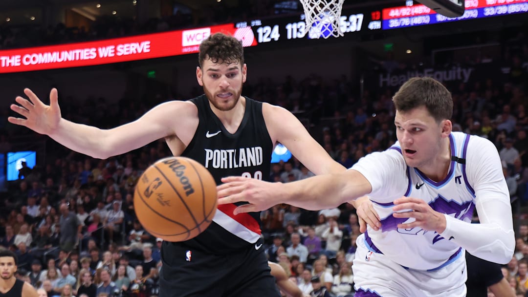 Oct 29, 2025; Salt Lake City, Utah, USA; Portland Trail Blazers center Donovan Clingan (23) and Utah Jazz center Walker Kessler (24) battle for the ball during the second half at Delta Center. Mandatory Credit: Rob Gray-Imagn Images
