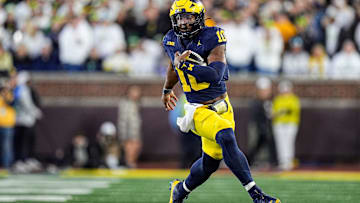 Michigan quarterback Alex Orji (10) runs against Oregon during the second half at Michigan Stadium