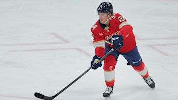 Dec 28, 2024; Sunrise, Florida, USA; Florida Panthers defenseman Adam Boqvist (34) moves the puck against the Montreal Canadiens during the third period at Amerant Bank Arena. Mandatory Credit: Sam Navarro-Imagn Images