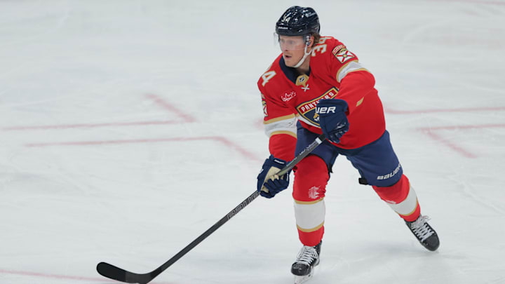 Dec 28, 2024; Sunrise, Florida, USA; Florida Panthers defenseman Adam Boqvist (34) moves the puck against the Montreal Canadiens during the third period at Amerant Bank Arena. Mandatory Credit: Sam Navarro-Imagn Images