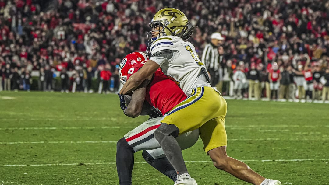 Nov 29, 2024; Athens, Georgia, USA; Georgia Bulldogs wide receiver Dominic Lovett (6) catches a touchdown pass in front of Georgia Tech Yellow Jackets defensive back Syeed Gibbs (16) during the second half at Sanford Stadium. Mandatory Credit: Dale Zanine-Imagn Images
