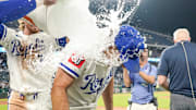 Kansas City Royals second baseman Adam Frazier (26) is doused by shortstop Bobby Witt Jr. (7) and right fielder designated hitter Carter Jensen (22) after the win over the Seattle Mariners at Kauffman Stadium.