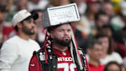 Fans watch in the stands as the Arizona Cardinals play against the Green Bay Packers at State Farm Stadium in Glendale on Oct. 19, 2025.