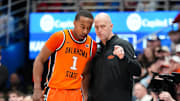 Feb 22, 2025; Lawrence, Kansas, USA; Oklahoma State Cowboys guard Bryce Thompson (1) talks with head coach Steve Lutz against the Kansas Jayhawks during the first half at Allen Fieldhouse. Mandatory Credit: Denny Medley-Imagn Images